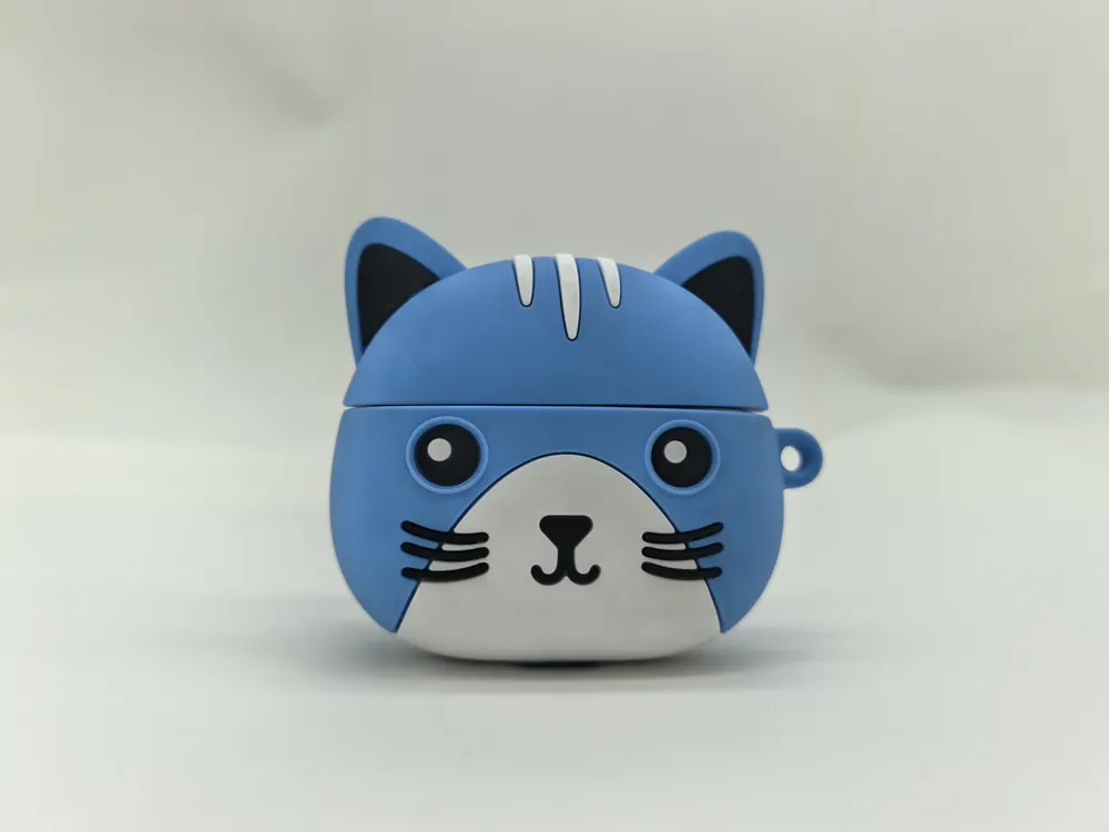 Blue silicone earbud case moulded as a cat head, with moulded ears, printed eyes and a loop.